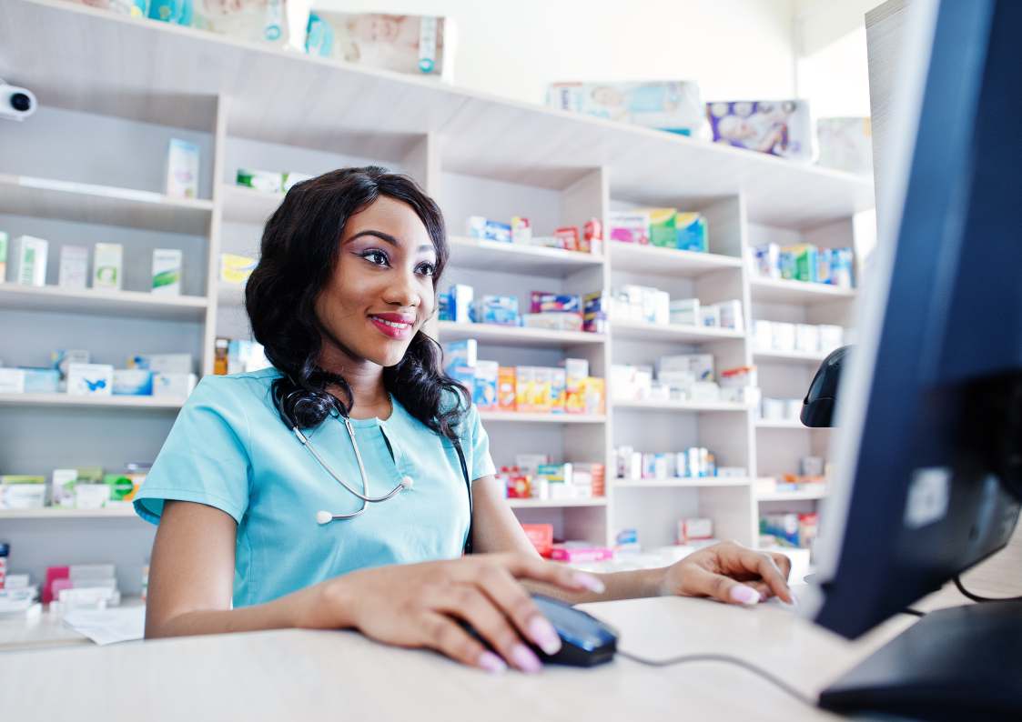 Dovizia pharmacist reviewing stock on a pharmacy shelf